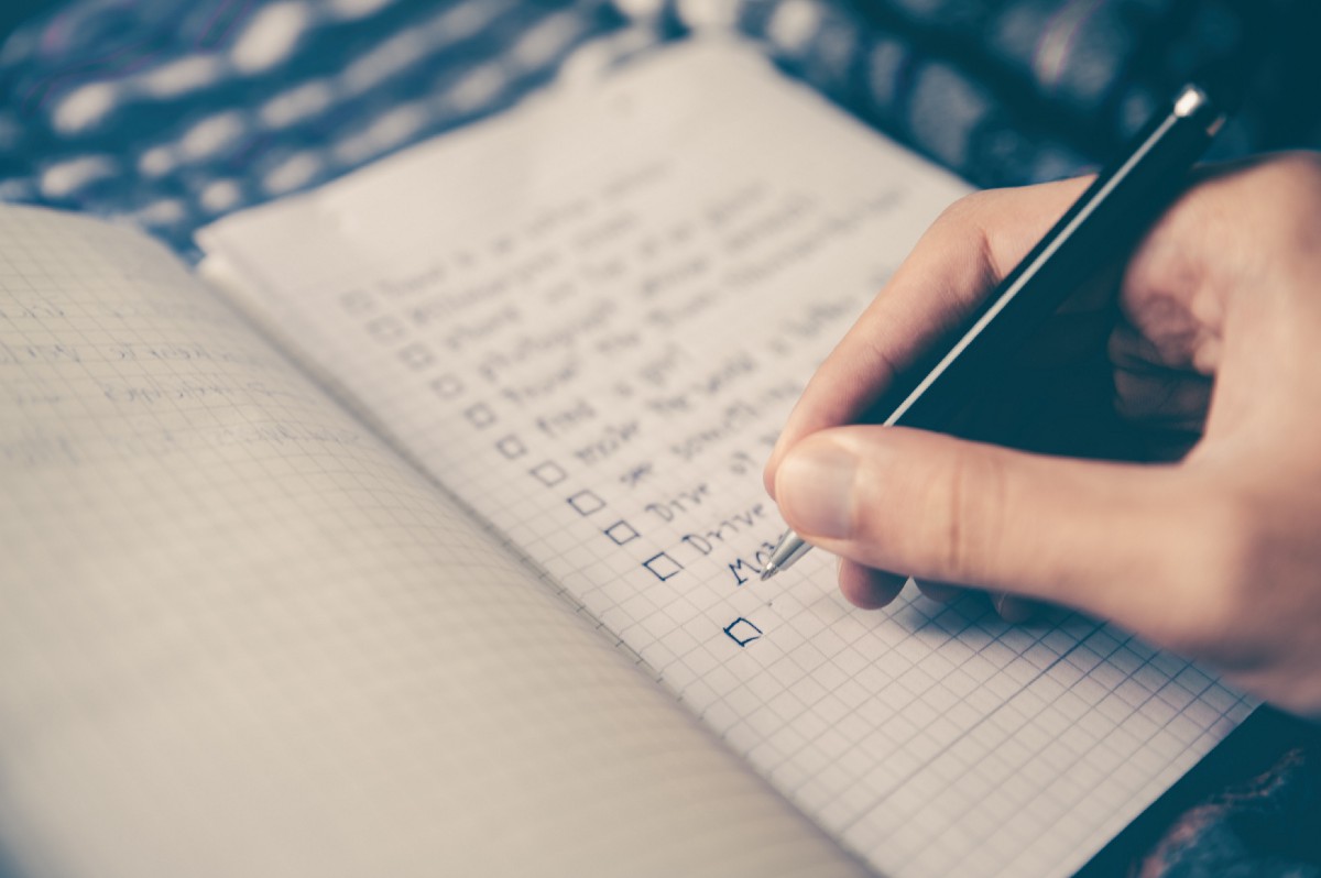 employee writing down a to-do list in a notebook, crosslead, washington dc