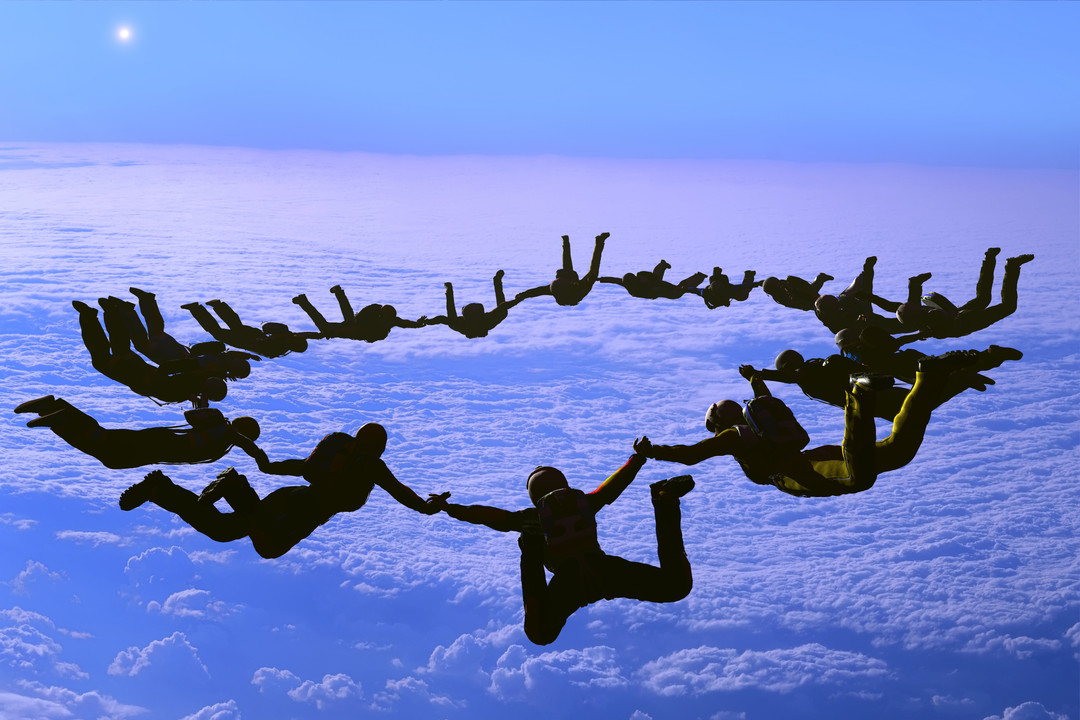 group of people skydiving at sunset, crosslead, leadership development, washington dc